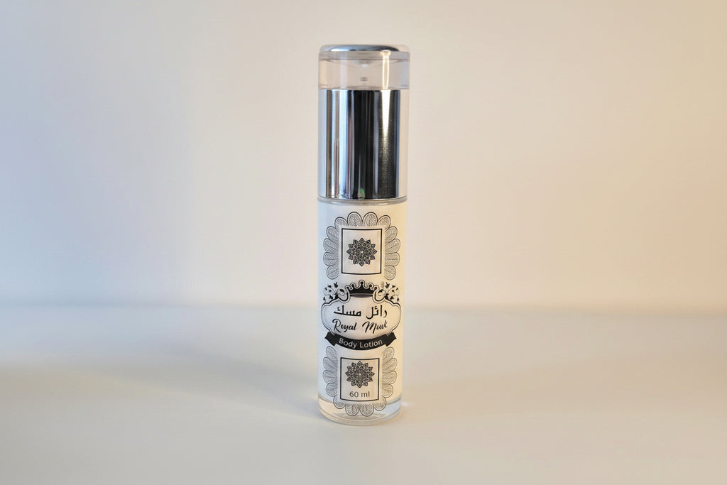 Clear glass bottle with a decorative label on a light gray background