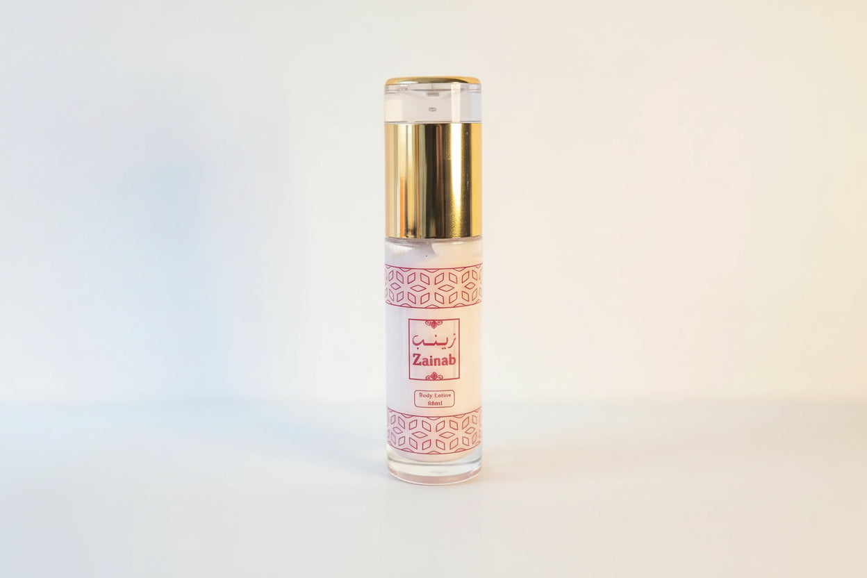 Perfume bottle with gold cap and white label on a light background