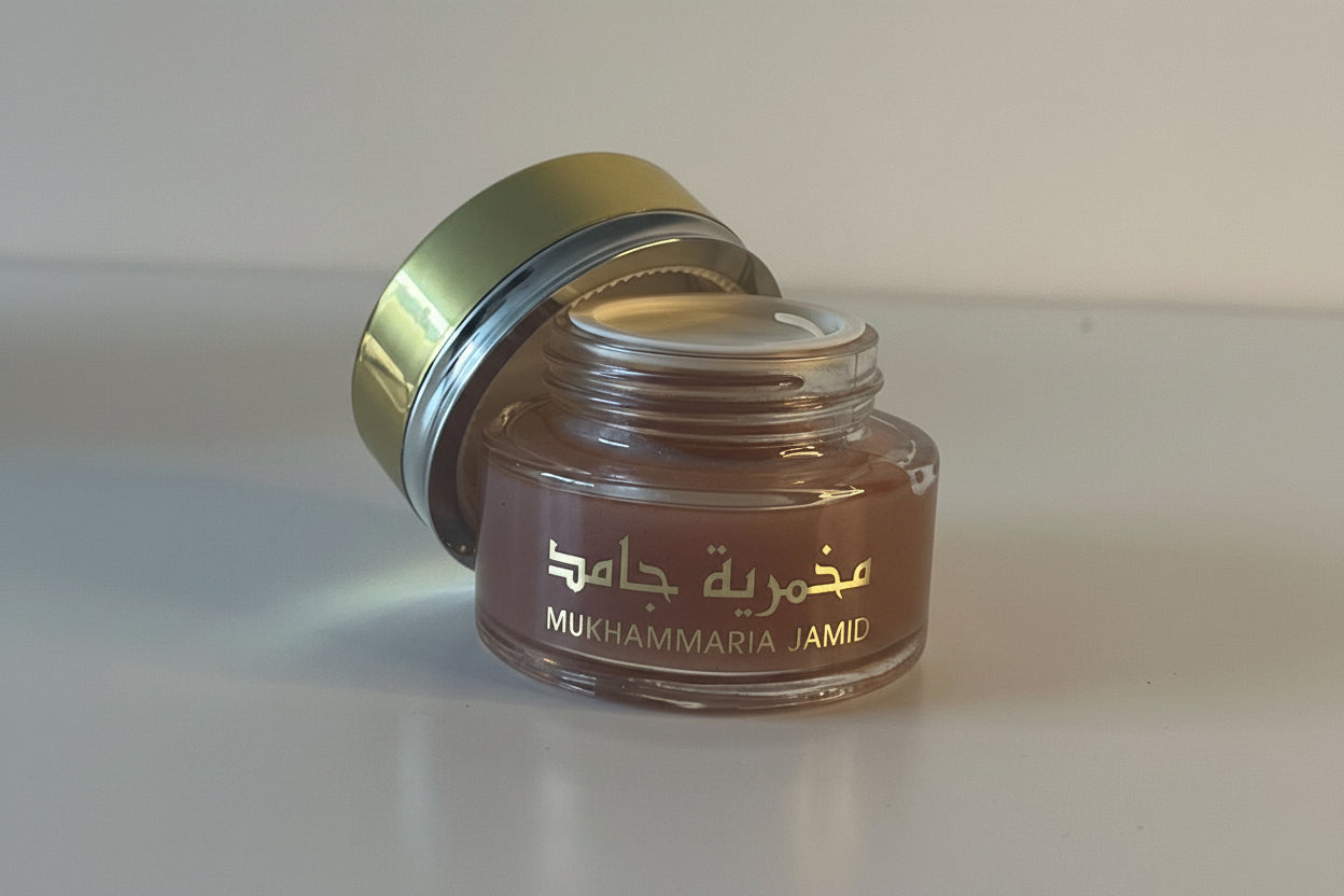 Small brown jar with a gold lid on a white surface